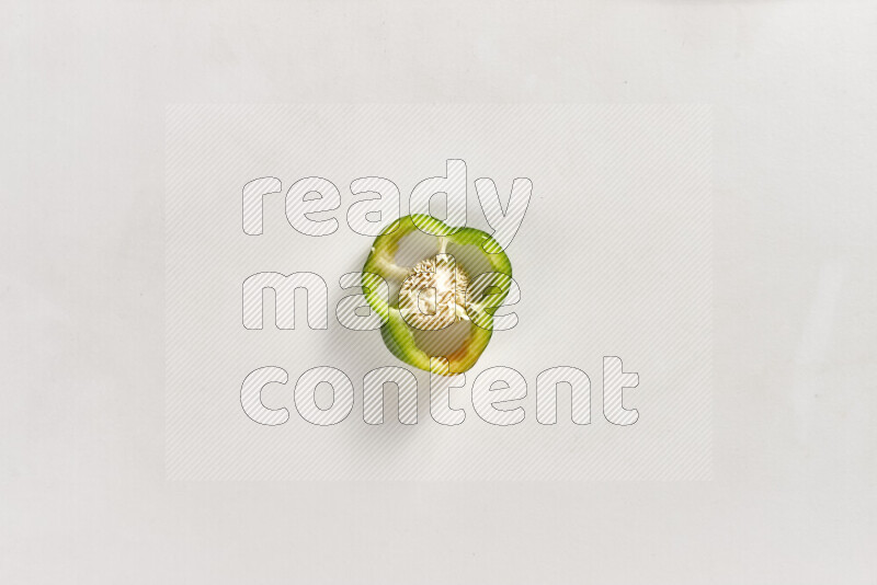 Green bell pepper slices on white background