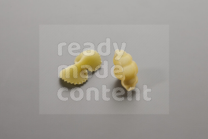 Fiocchi pasta with other types of pasta on grey background