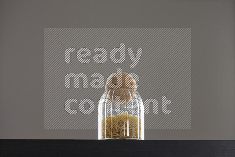 Snacks in a glass jar on black background