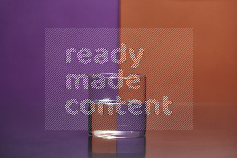 The image features a clear glassware filled with water, set against purple and dark orange background