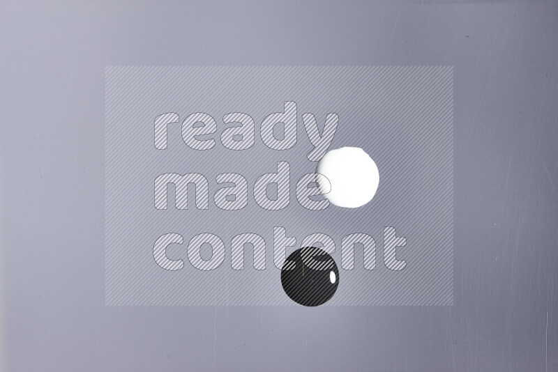 Close-ups of abstract white and black paint droplets on the surface