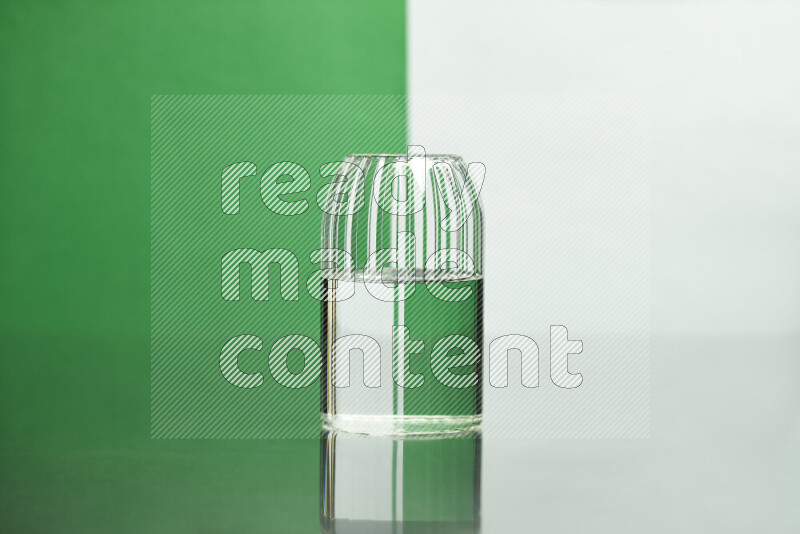 The image features a clear glassware filled with water, set against white and green background