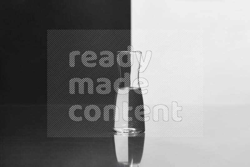 The image features a clear glassware filled with water, set against white and black background