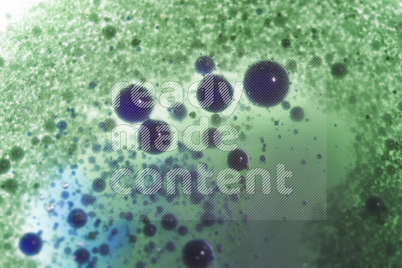 Close-ups of abstract green and blue watercolor drops on oil Surface on white background