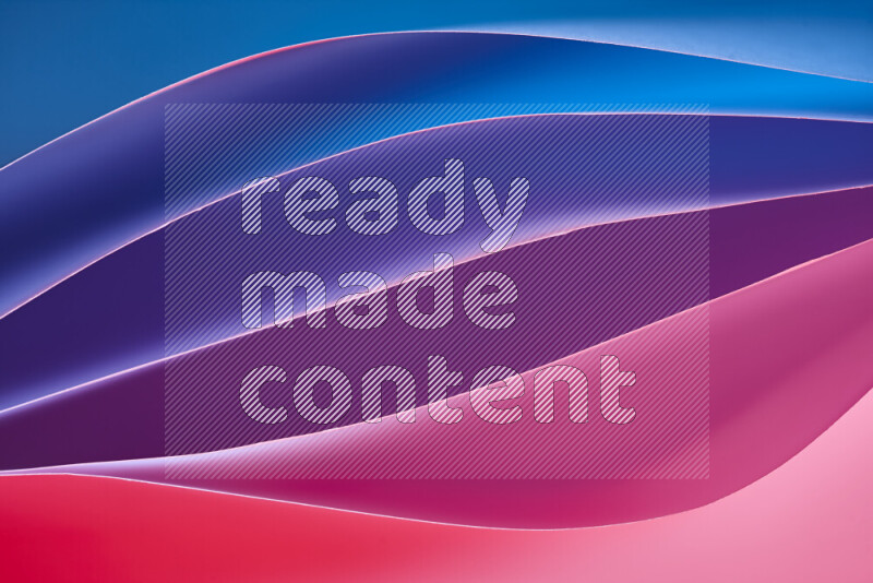 This image showcases an abstract paper art composition with paper curves in blue, purple and red gradients created by colored light