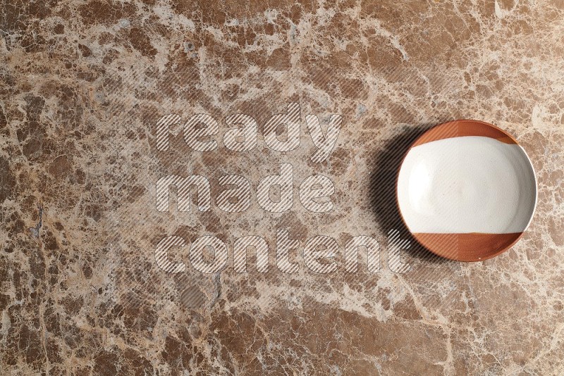 Top View Shot Of A Decorative Pottery Plate On beige Marble Flooring