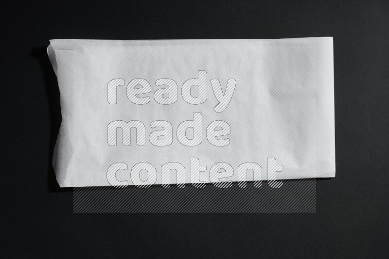 White paper sheet on black background