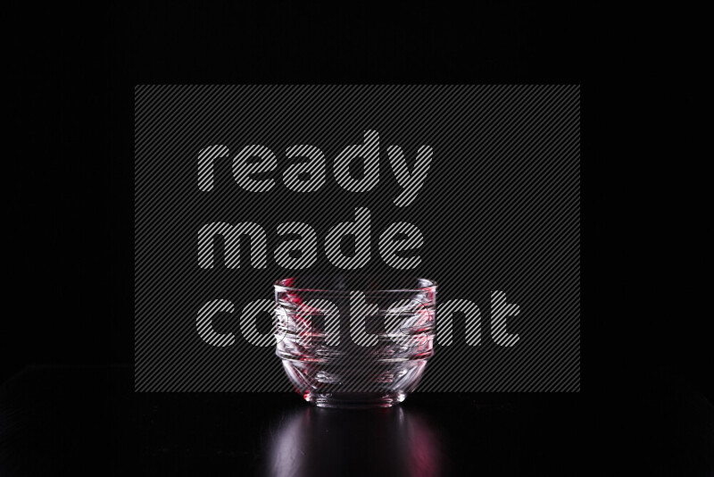 Glassware with rim light in red and white against black background