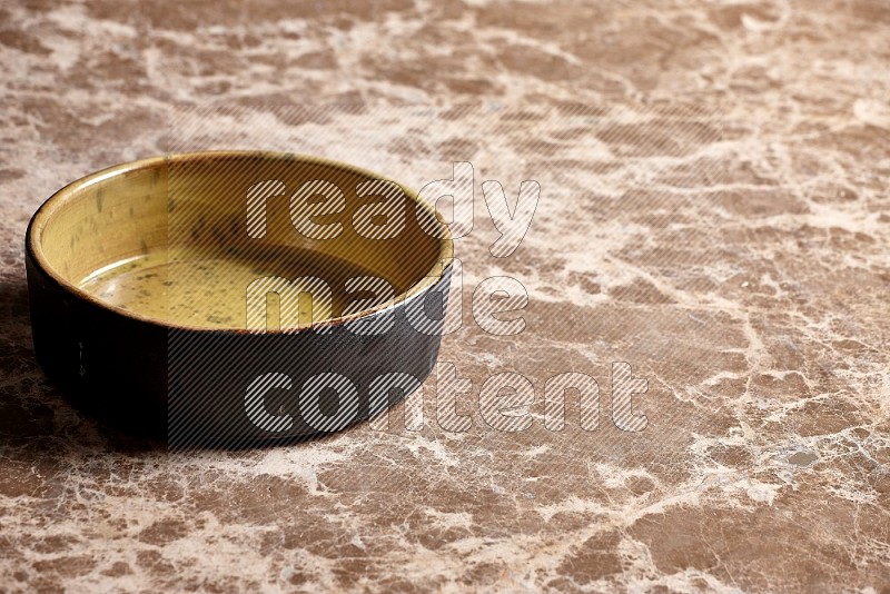 Multicolored Pottery Oven Plate on Beige Marble Flooring, 45 degrees
