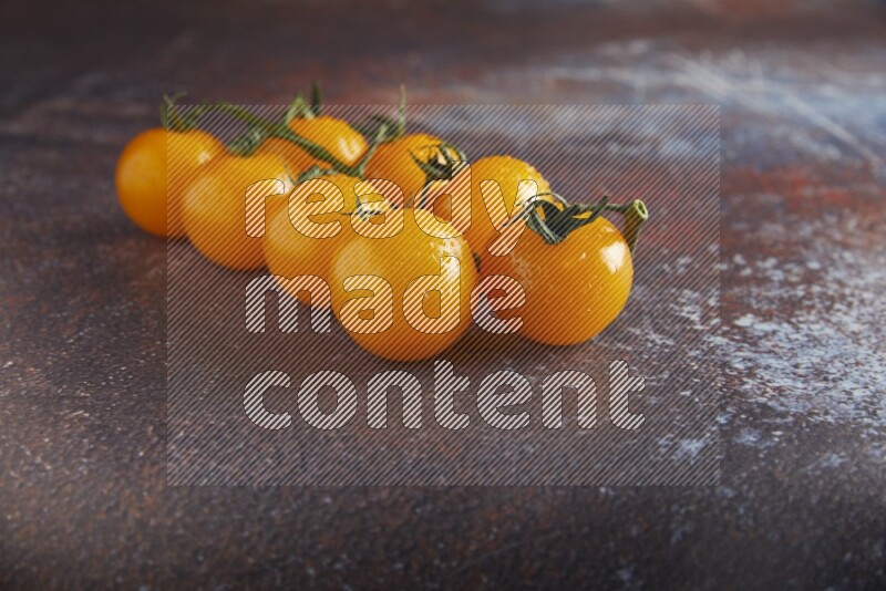 Yellow cherry tomato vein on reddish rustic metal background 45 degree