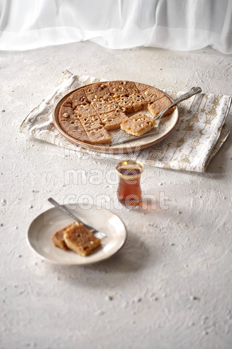 Basbousa with tea in a light setup