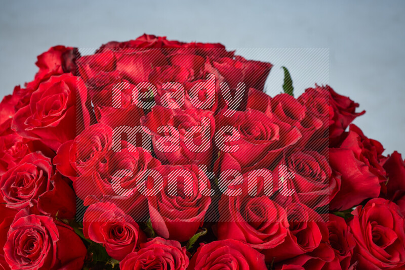 A luxurious bouquet of red roses on black marble background