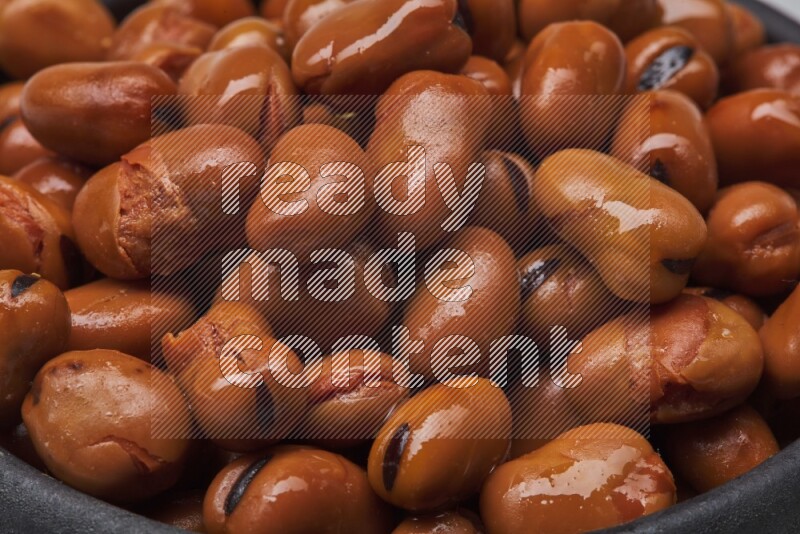 Close up shot of cooked fava beans (foul) on white background