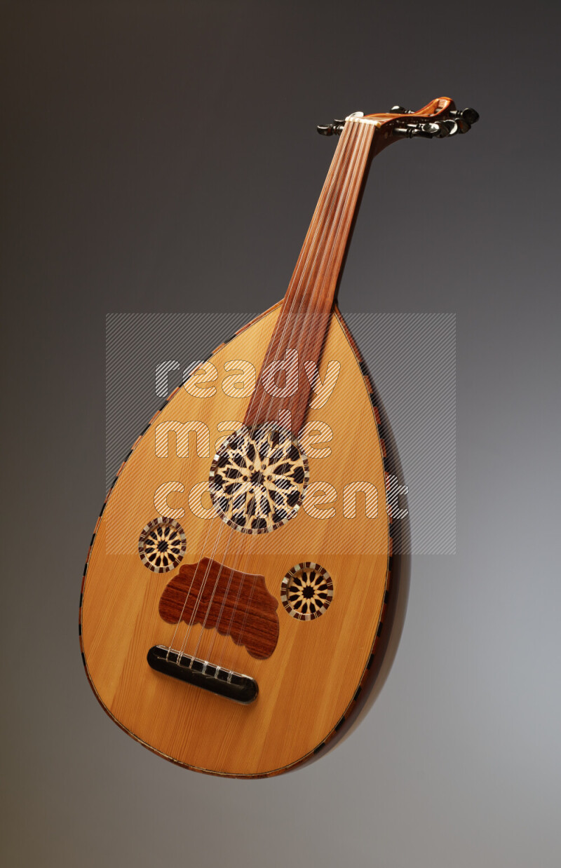 a wooden brown Oud on a gray background