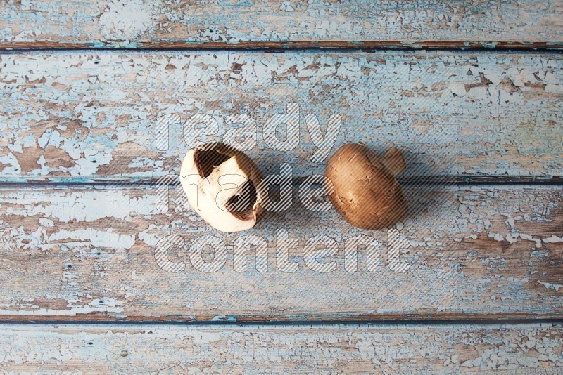 small fresh Cremini mushrooms topview on wooden blue background