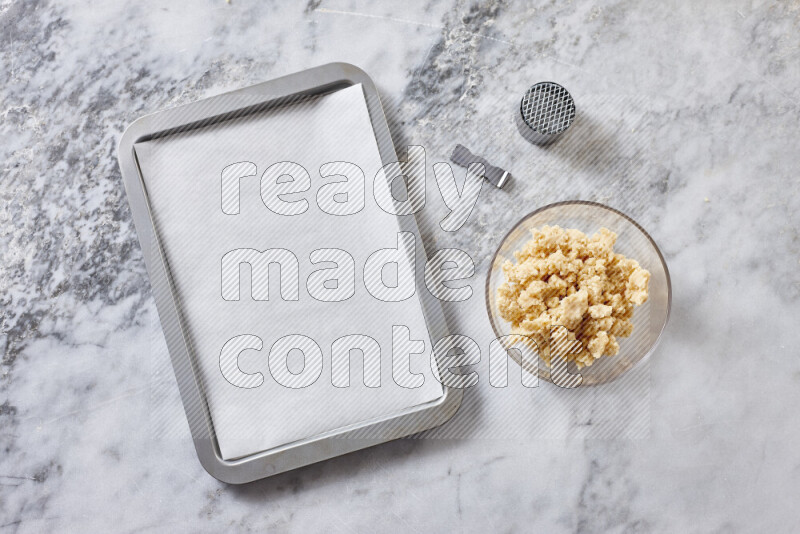 Kahk step by step with its ingredients ghee, sugar, flour, sesame, yeast, water and kahk flavor on grey marble background