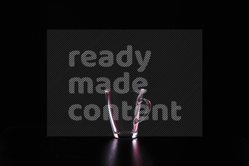 Glassware with rim light in red and white against black background