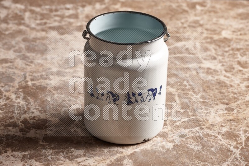 A vintage milk can on beige marble background