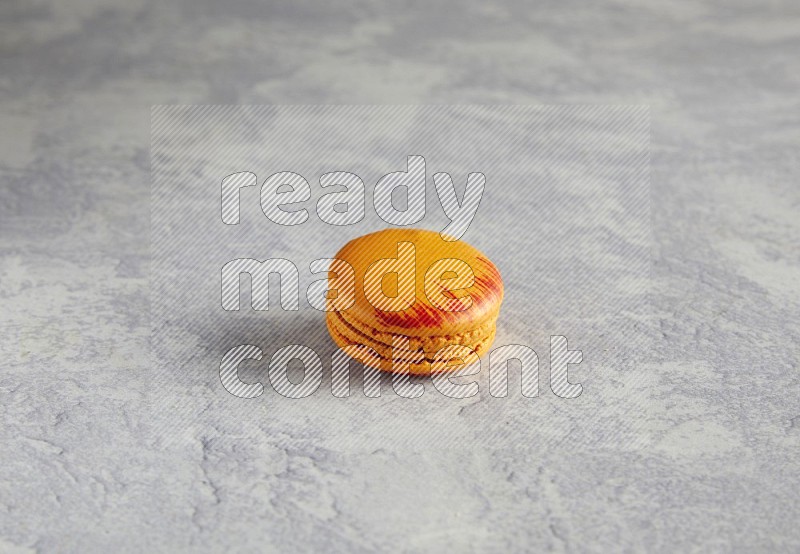 45º Shot of Orange Exotic macaron on white  marble background