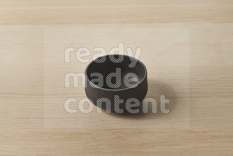 Black Pottery Bowl on Oak Wooden Flooring, 45 degrees