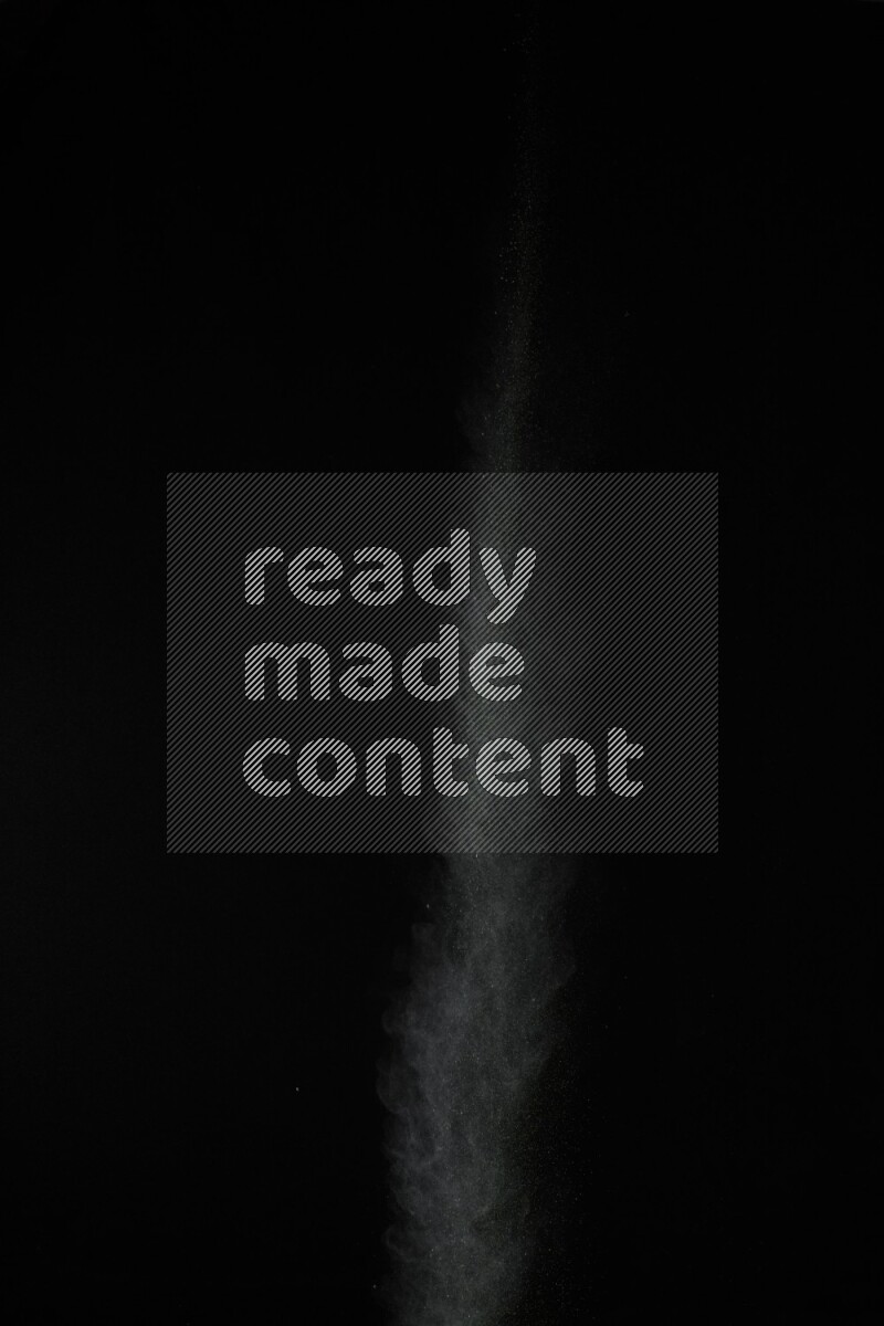 A side view of green powder explosion on black background