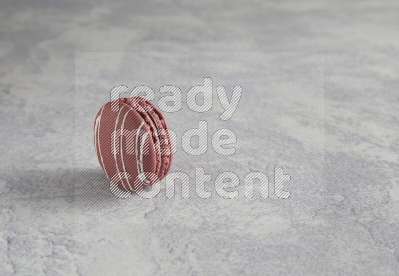 45º Shot of Red Poppy Flower macaron on white  marble background