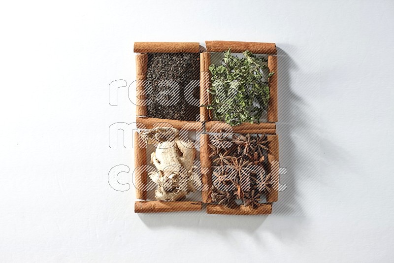 4 squares of cinnamon sticks full of tea, mint, star anise and ginger on white flooring