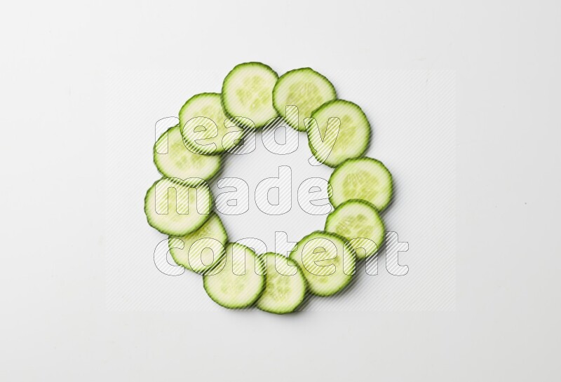 Multiple cucumber slices on white background