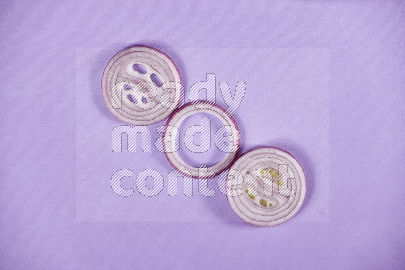 Red onions rings on purple background