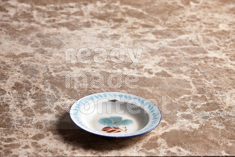 A vintage metal plate on beige marble background
