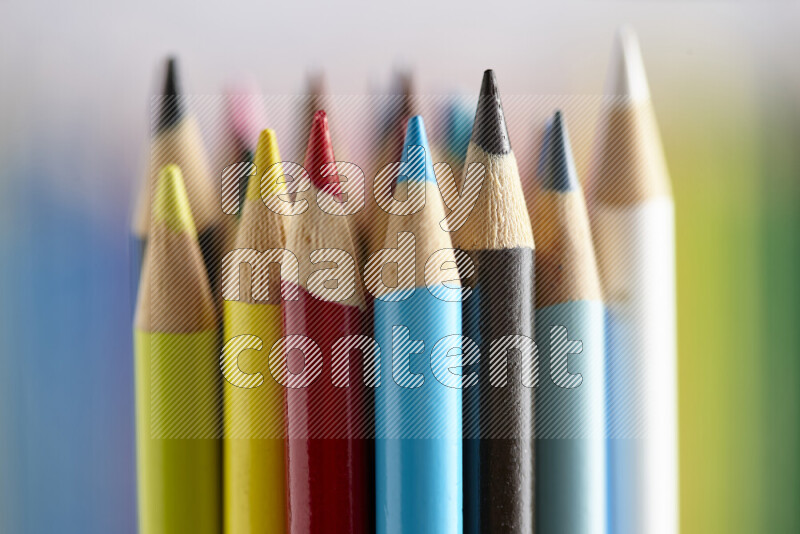 The image captures a close-up of sharpened colored pencils on multicolored background