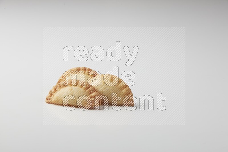 Three fried sambosas on a white background