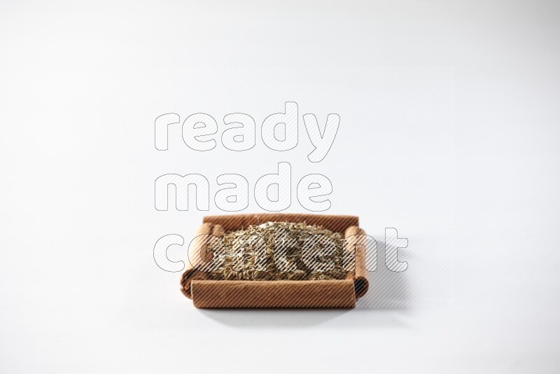 A single square of cinnamon sticks full of cumin on white flooring