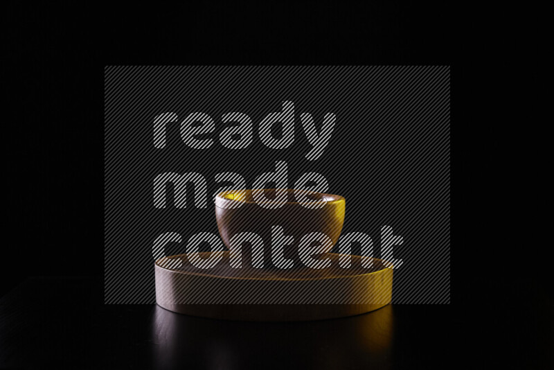 Wooden kitchen essentials with colored rim light against black background