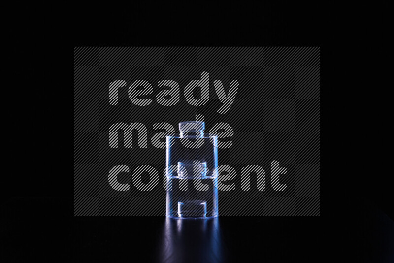 Glassware with rim light in blue and white against black background