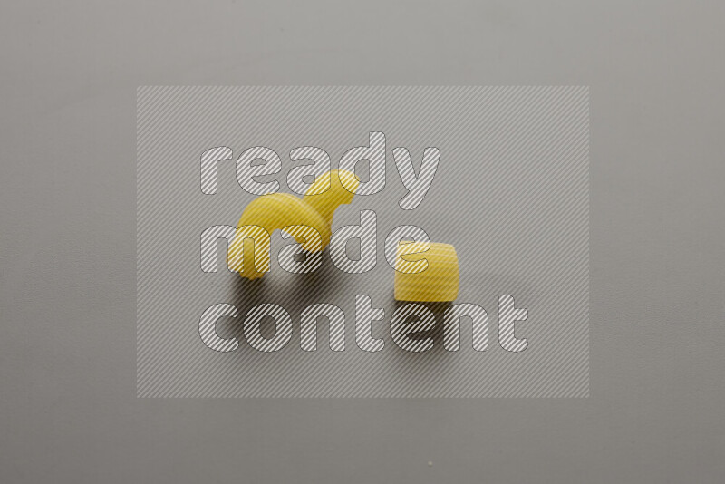 Twist pasta with other types of pasta on grey background