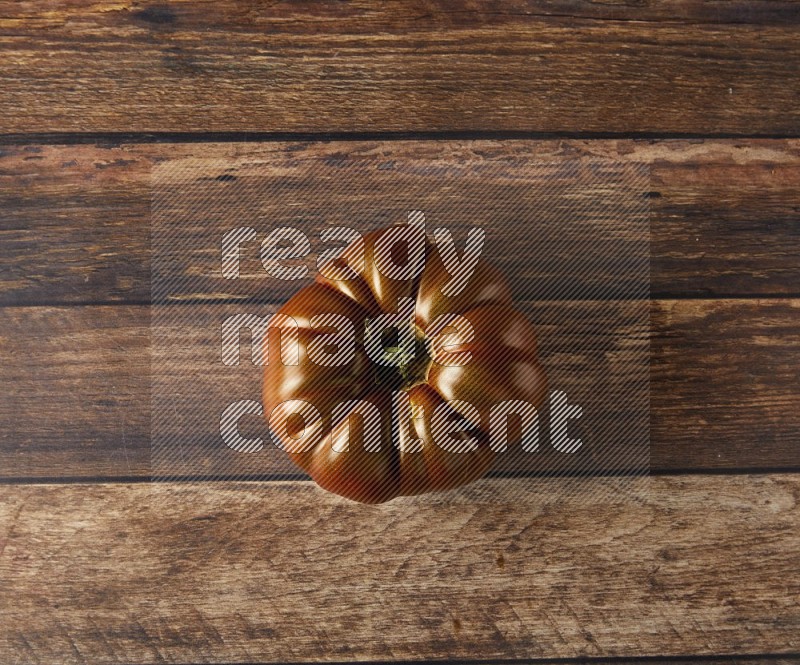 Single topview Heiloom Tomato on a wooden background