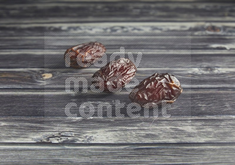 three madjoul date on a wooden grey background
