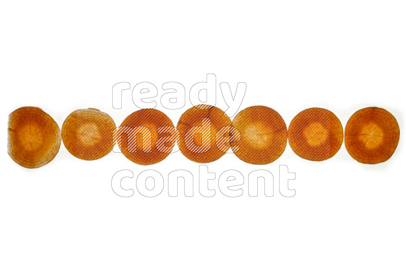 Carrots slices on illuminated white background