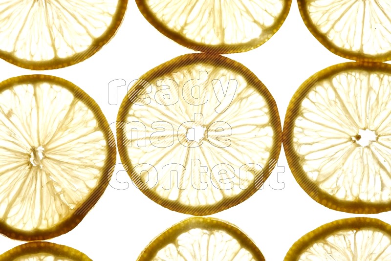 Lemon slices on illuminated white background