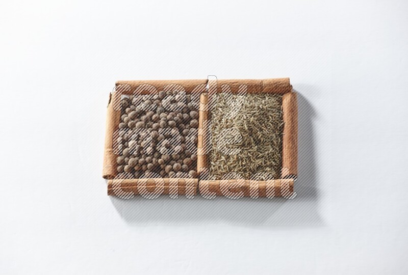 2 squares of cinnamon sticks full of allspice and cumin on white flooring