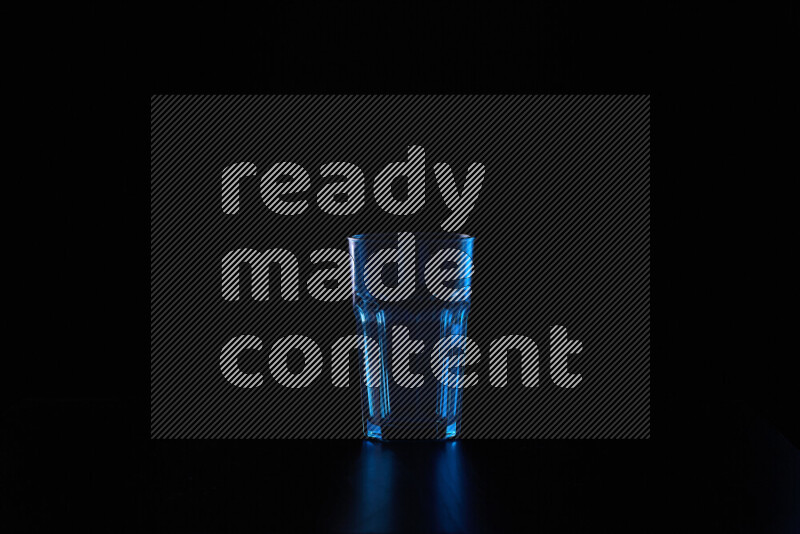 Glassware with rim light in blue and white against black background