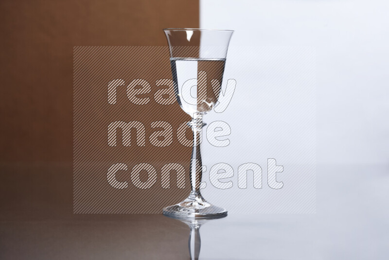 The image features a clear glassware filled with water, set against white and brown background