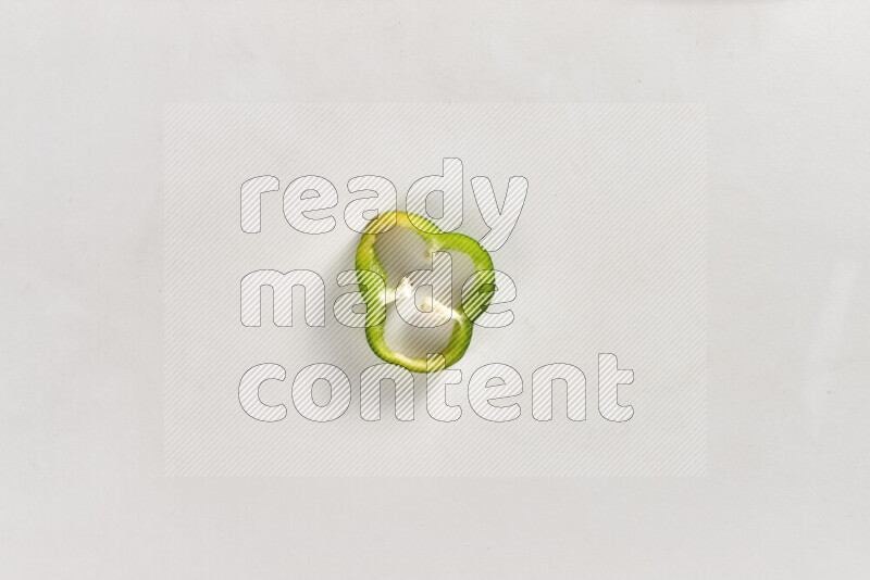 Green bell pepper slices on white background