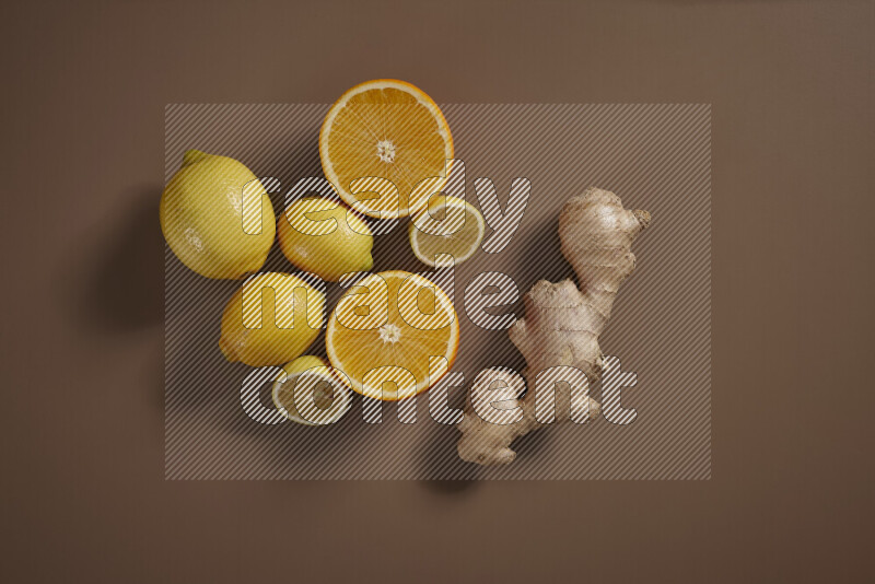 Fresh ginger root with different ingredients such as lemon, orange, honey, ground ginger on beige baackground