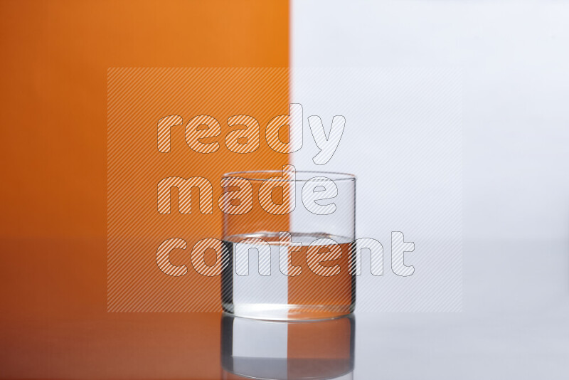 The image features a clear glassware filled with water, set against white and orange background