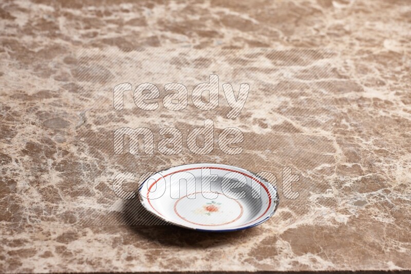 A vintage metal plate on beige marble background