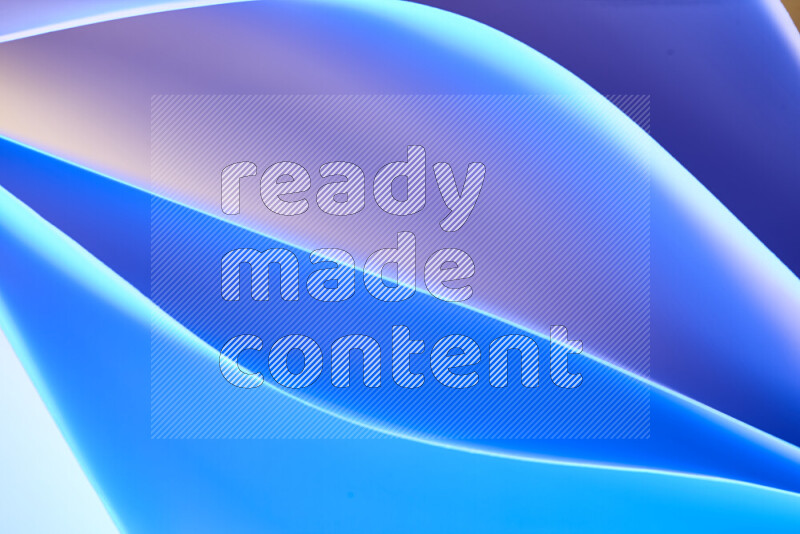 This image showcases an abstract paper art composition with paper curves in blue gradients created by colored light