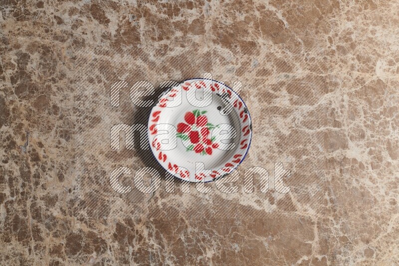 A vintage metal plate on beige marble background