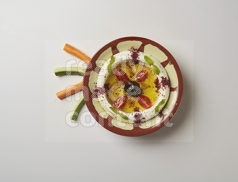 Lebnah garnished with Cherry tomato, mint & sumak  in a traditional plate on a white background